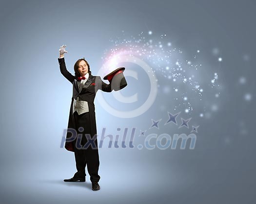 Image of magician holding hat with lights and fumes going out Image of magician holding hat with lights and fumes going out