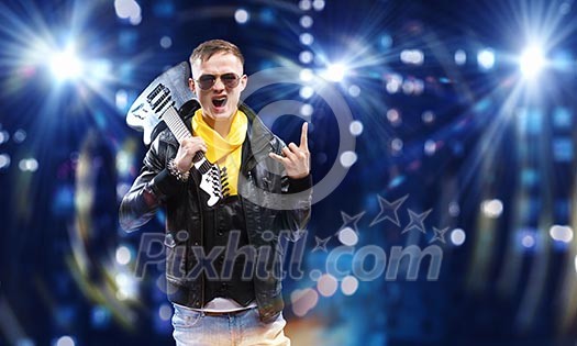 Young man, rock musician in jacket with guitar