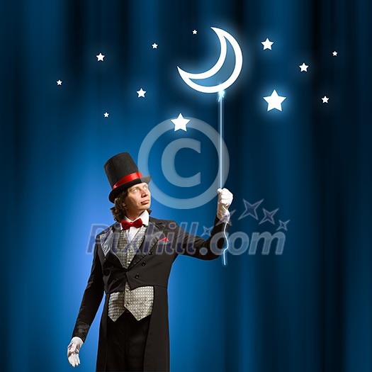 Image of man magician with balloon against color background Image of man magician with balloon against color background