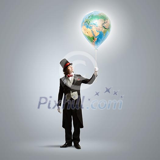 Image of magician in hat holding globe. Ecology concept. Elements of this image are furnished by NASA Image of magician in hat holding globe. Ecology concept. Elements of this image are furnished by NASA