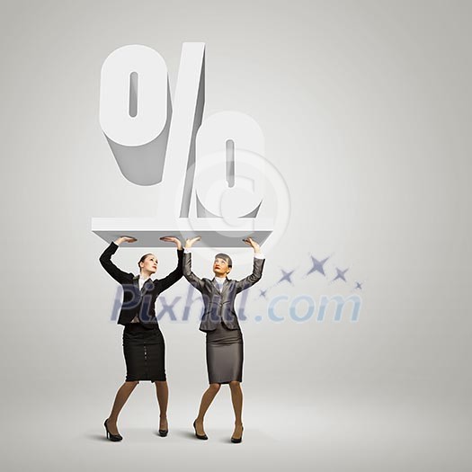 Image of two businesswomen holding percentage symbol above head