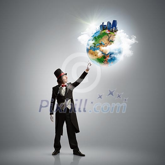 Image of magician in hat holding globe. Ecology concept. Elements of this image are furnished by NASA Image of magician in hat holding globe. Ecology concept. Elements of this image are furnished by NASA