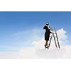 Image of businesswoman standing on ladder and looking in binoculars