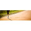 Detail of legs of a female runner on road - jog workout/well-being concept