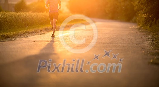 Male athlete/runner running on road - jog workout well-being concept Male athlete/runner running on road - jog workout well-being concept