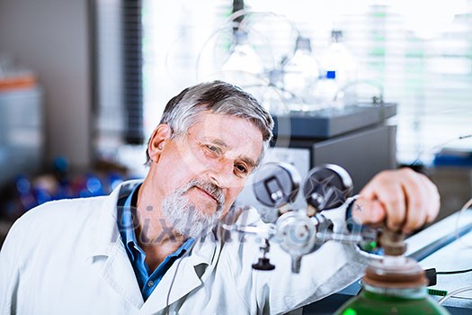 Senior male researcher carrying out scientific research in a lab (shallow DOF; color toned image) Senior male researcher carrying out scientific research in a lab (shallow DOF; color toned image)