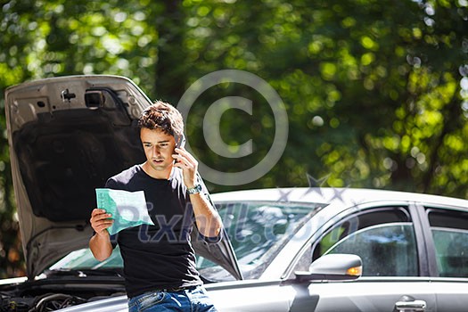 Handsome young man calling for assistance with his car broken down by the roadside Handsome young man calling for assistance with his car broken down by the roadside
