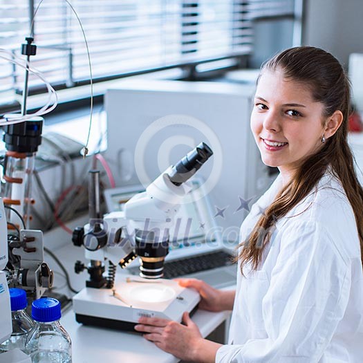 Portrait of a female chemistry student carrying out research in a chemistry lab (color toned image; shallow DOF)