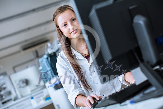 Portrait of a female chemistry student carrying out research in a chemistry lab (color toned image; shallow DOF)