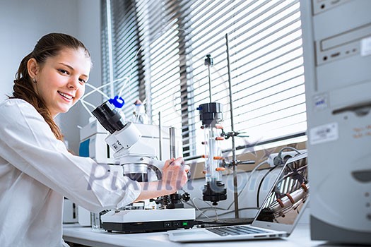 Portrait of a female chemistry student carrying out research in a chemistry lab (color toned image; shallow DOF)