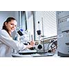 Portrait of a female chemistry student carrying out research in a chemistry lab (color toned image; shallow DOF)