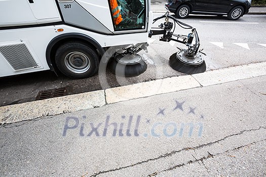 Detail of a street sweeper machine/car cleaning the road Detail of a street sweeper machine/car cleaning the road