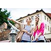 Two pretty, young women sightseeing in Prague historic center