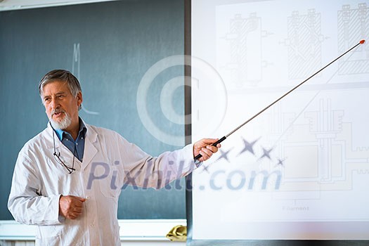 Senior chemistry professor giving a lecture in front of classroom full of students (shallow DOF; color toned image) Senior chemistry professor giving a lecture in front of classroom full of students (shallow DOF; color toned image)
