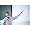 Senior chemistry professor giving a lecture in front of classroom full of students (shallow DOF; color toned image)