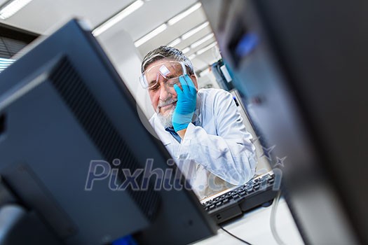 Senior male researcher carrying out scientific research in a lab - dozing off for a while in a funny way (shallow DOF; color toned image) Senior male researcher carrying out scientific research in a lab - dozing off for a while in a funny way (shallow DOF; color toned image)