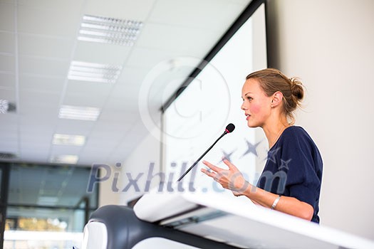 Pretty young business woman giving a presentation in a conference/meeting setting (shallow DOF; color toned image) Pretty young business woman giving a presentation in a conference/meeting setting (shallow DOF; color toned image)