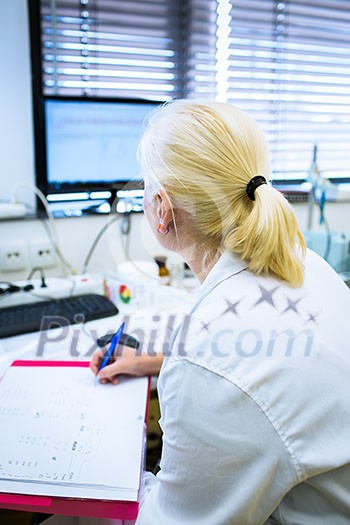 Portrait of a female researcher doing research in a lab (shallow DOF; color toned image) Portrait of a female researcher doing research in a lab (shallow DOF; color toned image)