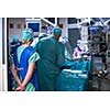 Team of surgeon in uniform perform operation on a patient at cardiac surgery clinic