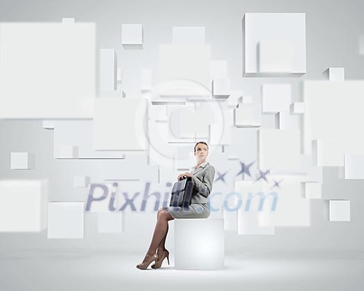 Image of elegant businesswoman sitting on white cube touching media button Image of elegant businesswoman sitting on white cube touching media button