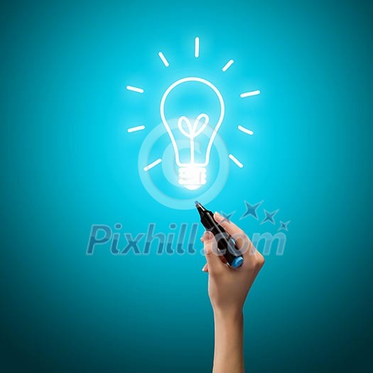 Close up image of human hand drawing electrical bulb Close up image of human hand drawing electrical bulb