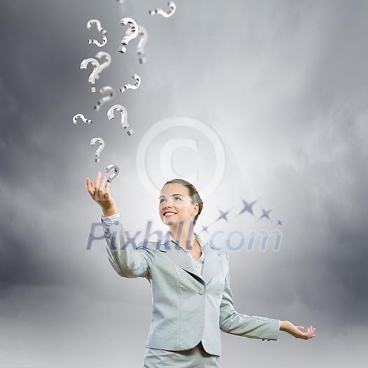 Image of young attractive businesswoman holding question marks in hand