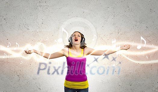 Image of young woman wearing headphones and singing Image of young woman wearing headphones and singing