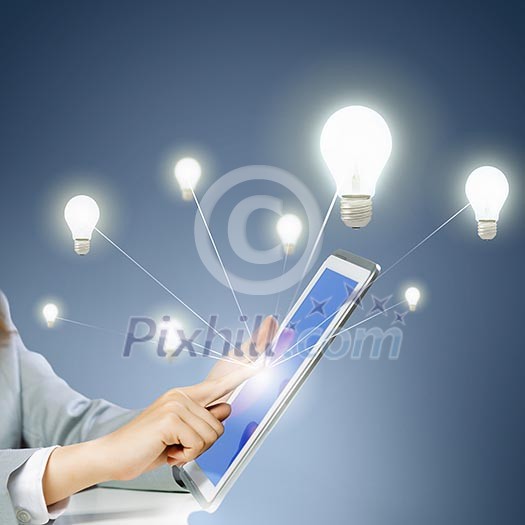 Close up image of human hand touching screen of tablet pc Close up image of human hand touching screen of tablet pc