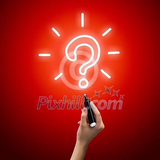 Close up image of human hand drawing question mark with marker Close up image of human hand drawing question mark with marker