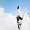 Image of young ambitious businesswoman climbing ladder. Promotion concept