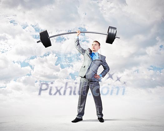 Image of strong businessman lifting barbell above head with one hand Image of strong businessman lifting barbell above head with one hand