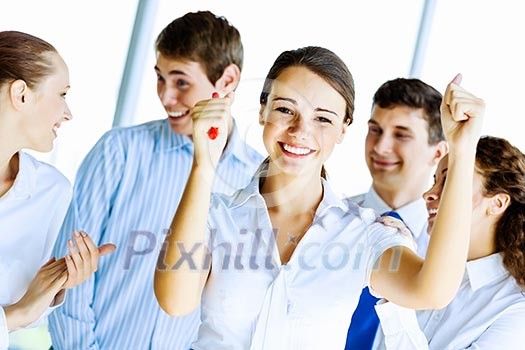 Image of young businesspeople congratulating colleague. Success concept