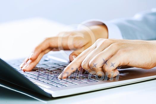 Close up image of businesswoman hands typing on keyboard