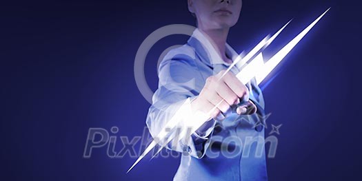 Image of powerful businesswoman holding lightning in fist Image of powerful businesswoman holding lightning in fist