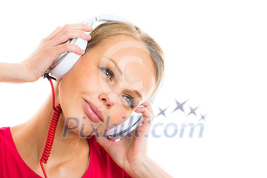 Pretty, young woman listening to her favorite music on hi-fi headphones, dancing, enjoying the tune, having a moment for herself