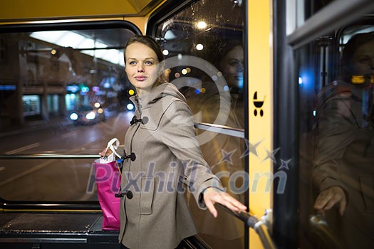 Pretty, young woman on a streetcar/tramway, during her evening commute home from work (color toned image; shallow DOF) Pretty, young woman on a streetcar/tramway, during her evening commute home from work (color toned image; shallow DOF)