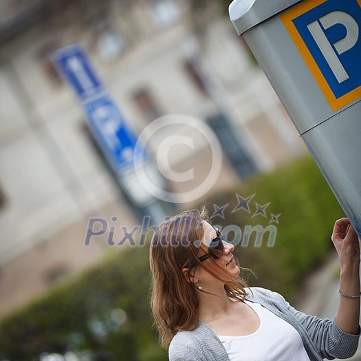 Young woman paying for parking Young woman paying for parking