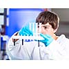 Young male researcher carrying out scientific research in a lab (shallow DOF; color toned image)