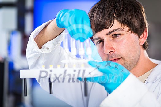 Young male researcher carrying out scientific research in a lab (shallow DOF; color toned image) Young male researcher carrying out scientific research in a lab (shallow DOF; color toned image)