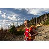 Pretty, female hiker going downhill in warm evening light