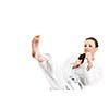 Beautiful caucasian, young, woman makes a kick in karate kimono on white background