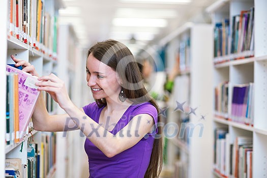 In the library - pretty, female student searching for books in a high school/university library (color toned image)