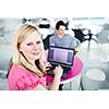 Two college students having fun studying together, using a laptop computer on campus, between classes (shallow DOF, color toned image)