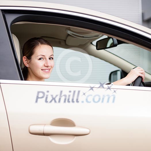 Pretty young woman driving her new car Pretty young woman driving her new car