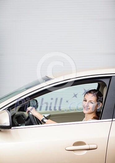 Pretty young woman driving her new car Pretty young woman driving her new car