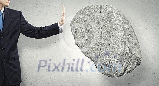 Businessman in suit huge holding stone in palm Businessman in suit huge holding stone in palm