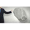 Businessman in suit huge holding stone in palm