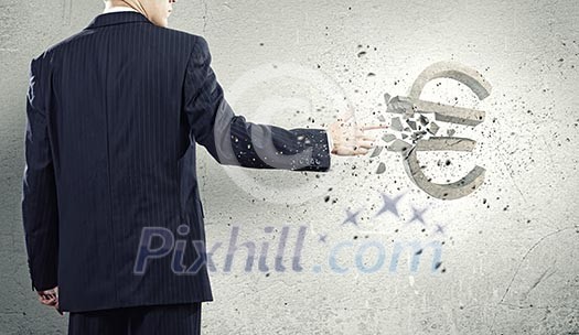 Businessman breaking euro stone symbol with finger touch