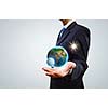 Close up of businessman holding Earth planet in palm. Elements of this image are furnished by NASA