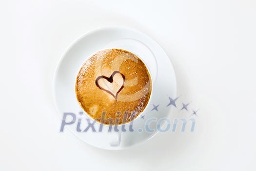 Close up view of cup of coffee with heart ornament